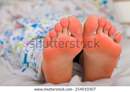 Picture of a woman's foot relaxing in the bed