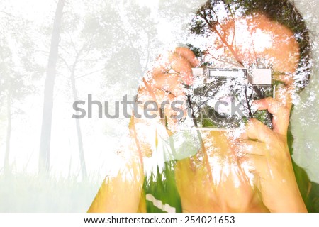 double exposure image of young girl holding old camera and nature background