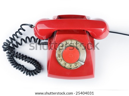 An old red phone on a white background