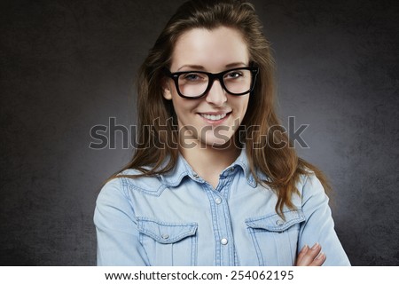 Smiling cute teenager in nerdy glasses