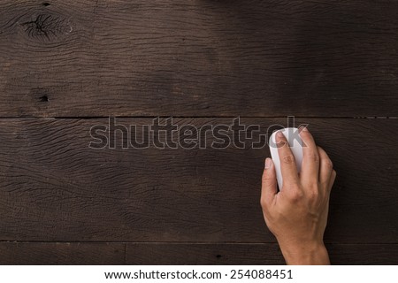 Hand using mouse on office table. View from top. Royalty-Free Stock Photo #254088451