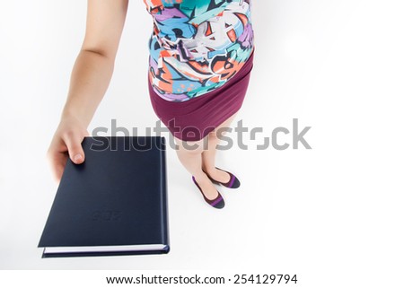 Showing woman holding book diary with copy space for your text or design. High angle view on white background.