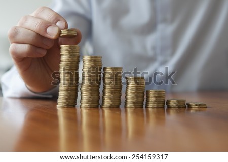 Finances, Person stacking Euro coins, close-up Royalty-Free Stock Photo #254159317