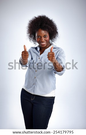 Portrait of happy mature woman giving double thumbs up on white background