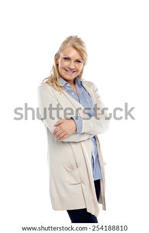 Studio shot of pretty mature woman standing with her arms crossed against white background