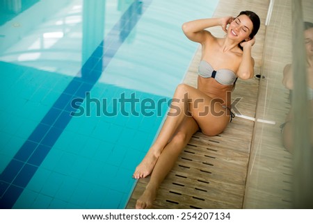 Pretty young woman by the pool