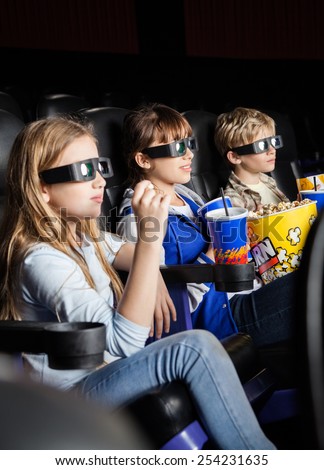 Children watching 3D movie together in cinema theater