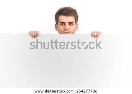 Happy smiling young business man showing blank signboard. Portrait Of Young Man Holding Placard Isolated On White Background 