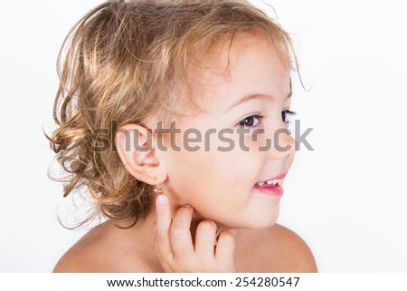 little girl with earring Royalty-Free Stock Photo #254280547