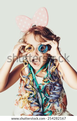 joyful little girl with confetti Royalty-Free Stock Photo #254282167