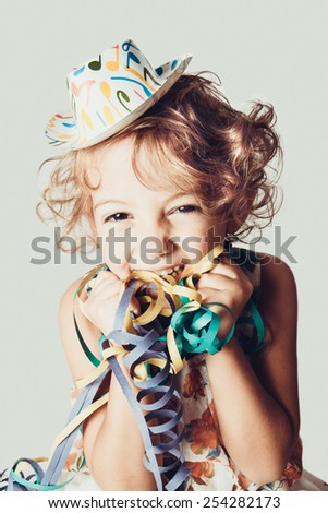 happy little girl with confetti Royalty-Free Stock Photo #254282173