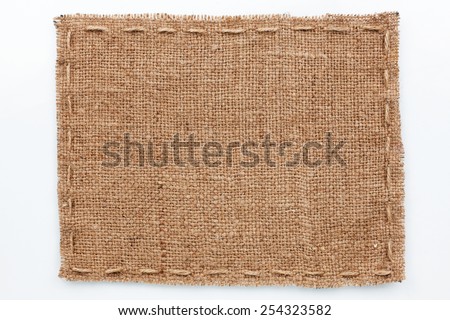 Frame of burlap  lies on a white  background, with place for your text Royalty-Free Stock Photo #254323582