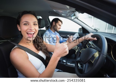 Young woman getting a driving lesson in the car Royalty-Free Stock Photo #254335081