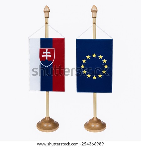 Slovak Republic and EU flag miniature in a stand on a white background .