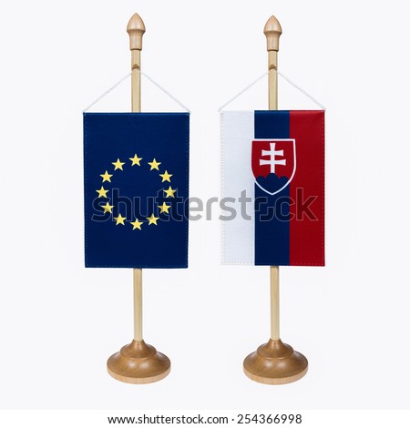 European Union and Slovak Republic flag miniature in a stand on a white background .