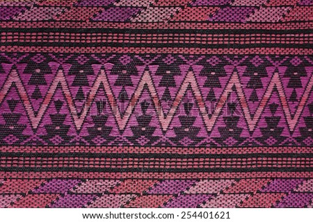 Woven handmade fabric with traditional guatemalan pattern, pink and purple colors. Arts and crafts from Guatemala, Central America.