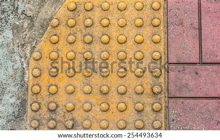 image of close up at Tactile paving texture for blind handicap on the road.