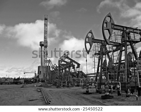 Work of oil industry. Construction and equipment of pump jack. Black and white photo