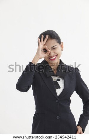 woman looking through hole from fingers