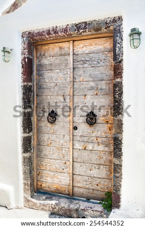 Old wooden door of the house. National Greek architecture on Santorini island