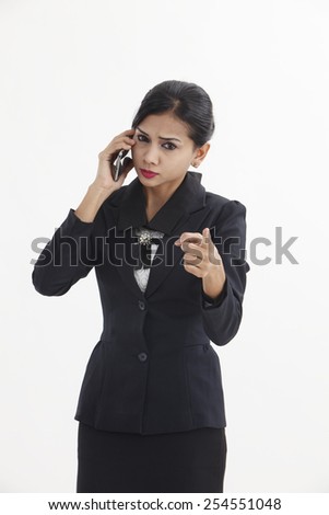 woman is feeling sad as she is talking on here mobile cell phone. A young woman being angry