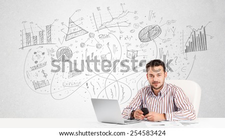 Business man at desk with hand drawn charts at the background