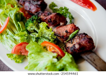 Roasted meat on the white plate. Barbecue. Restaurant