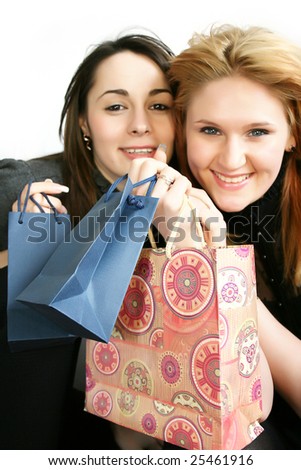 Two beautiful smiling young woman with shopping, gift bag