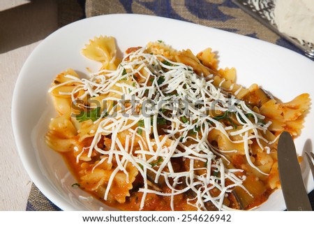 Traditional Sicilian pasta with aubergines, tomato sauce and salted ricotta cheese.