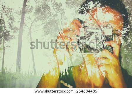 double exposure image of young girl holding old camera and nature background
