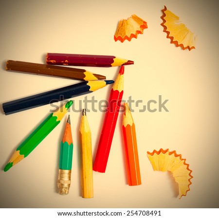 several vintage pencils and shavings on a white background, close-up. instagram image style