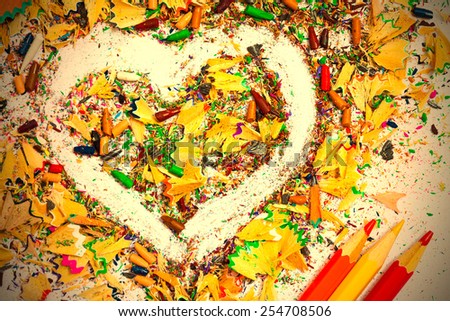 heart, multicolored pencils and varicolored wooden shavings close up. instagram image retro style