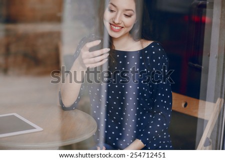 beautiful young girl enjoys phone and tablet
