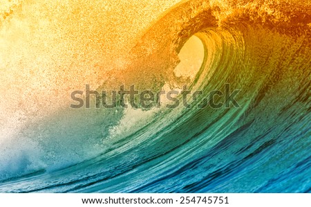 Beautiful big ocean wave with sunset color