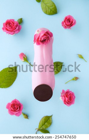 Exquisite cream dessert eclair sprinkled with fresh flowers of rose