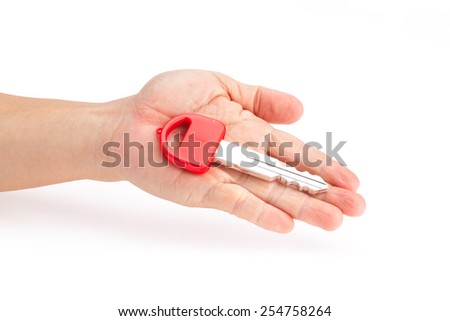 Red keys on hand of man, isolated white background.
