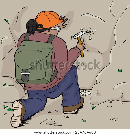Hispanic female geologist working with chisel on rock