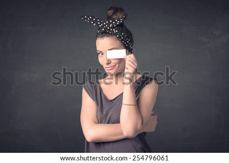 Pretty girl holding blank copy space paper at her eyes concept