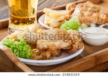 Traditional fish and chips with tartar sauce on a tray Royalty-Free Stock Photo #254831419