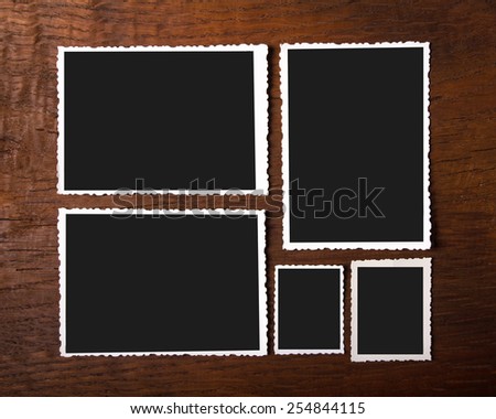 Group of different vintage photo frames on wooden background