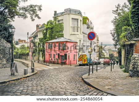 photo of a street in Montmartre, Paris, France, in a warm light and light toning Royalty-Free Stock Photo #254860054