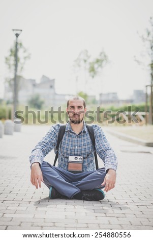 handsome hipster casual multitasking modern man with vintage camera in the city