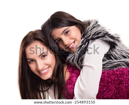 Fashion woman and girl posing over white background