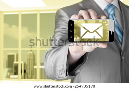 A man holding smartphone with one new message on a screen. Closeup shot.