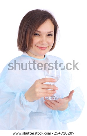 pretty young female doctor with the glass in her hand, focus on the glass