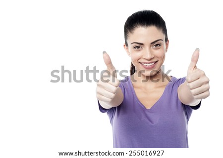 Smiling young woman showing thumbs up gesture