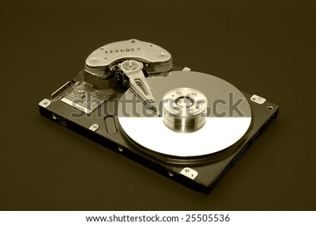 Opened computer hard drive isolated on black (sepia)