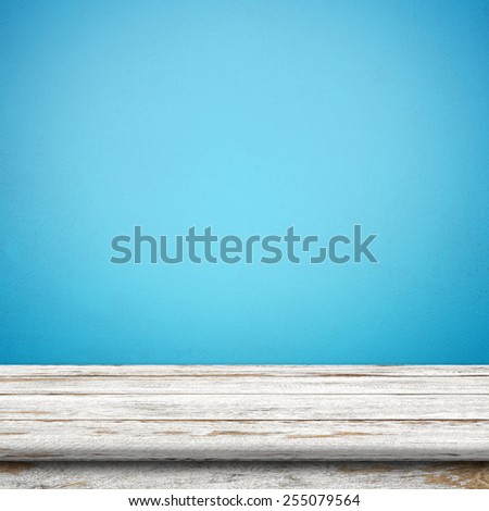 Vintage wood table in blue wall room. Royalty-Free Stock Photo #255079564