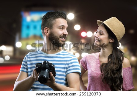 Trendy young hipster couple enjoying nightlife in the city