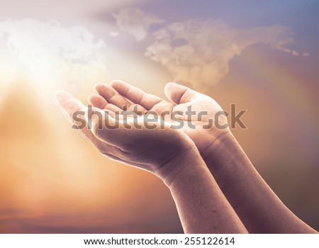 Faith God concept: Human open two empty hands with palms up over blurred world map of clouds with rainbow background